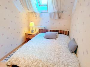 a small bedroom with a bed and a window at House near Vosges Park and La Petite Pierre in Hinsbourg