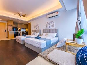 a bedroom with two beds and a living room at R&F Princess Cove by RR JBcity in Johor Bahru +151 photos