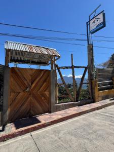 a building with a wooden gate and a bench at Casa Don 20 in San Marcos La Laguna