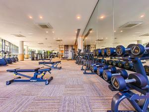 a gym with rows of dumbbells and other equipment at R&F Princess Cove by RR JBcity in Johor Bahru