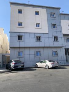 two cars parked in front of a building at Home apartment 2 in Medina