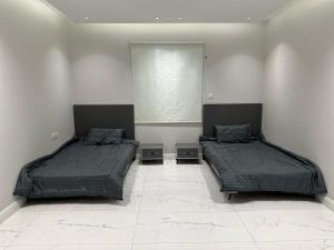 a bedroom with two beds and a window at Home apartment 2 in Medina