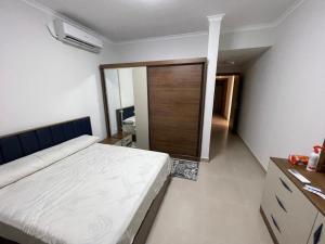 a bedroom with a bed and a sliding glass door at Gaia - Ras Elhekma- Notth coast in Zāwiyat al ‘Awwāmah