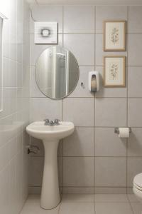 a bathroom with a sink and a mirror at Hotel Fundidora in Monterrey
