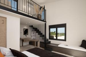 a living room with a staircase and a couch at Magical Crete Villa Villa Liváni Beautiful Landmark Views Terrace & Private Pool 4 Bedrooms Rethymno in Prínos