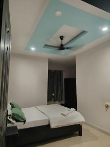 a room with a bed with a ceiling at Hotel Metro in Guwahati