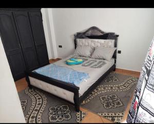 a bedroom with a bed with a black headboard at Complexe luxury 1 in Oued Laou