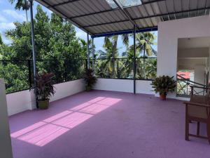 a large patio with potted plants in a building at DEN LODGE in Kulasegaram