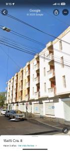 a building with a car parked in front of it at Flowers House Aptos - Centro Histórico in Valledupar +12 photos