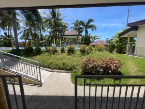 a view of a garden from a balcony at Reef Waters Resort in Pilar
