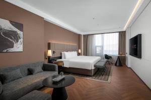 Ένα ή περισσότερα κρεβάτια σε δωμάτιο στο Intercity Hotel Guangzhou Pazhou Convention & Exhibition-the free shuttle bus for the canton fair