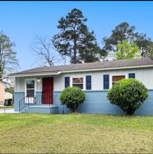 a blue and white house with a red door at Stunning, Pet-friendly Home in Savannah in Savannah