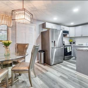 a kitchen with a table and a stainless steel refrigerator at Stunning, Pet-friendly Home in Savannah in Savannah