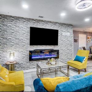 a living room with a tv and a brick wall at Stunning, Pet-friendly Home in Savannah in Savannah