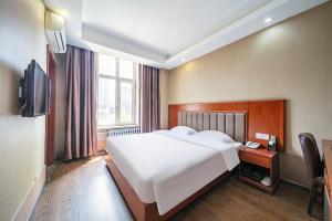 TV a/nebo společenská místnost v ubytování Harbin Huaxi Hotel - Ice World Branch