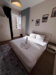 a bedroom with a white bed with a flower on it at Zeina's apartment in down town in Cairo