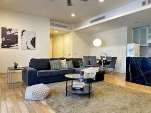 a living room with a blue couch and a table at St Mary Residence, Luxury 3B3R Family Suite with Balcony by Lilbean Space in Kuala Lumpur +60 photos