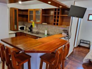 a kitchen with a wooden table and chairs at Paseo de la Fe in Salta