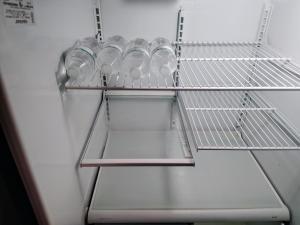 a refrigerator filled with water bottles on a shelf at One-Bedroom Suite Pool with Bath Kitchen in West Palm Beach in West Palm Beach +3 photos