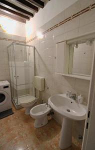 a bathroom with a toilet and a sink at Beautiful Center Apartments - posti auto privati prenotabili in Parma