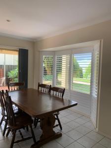 a dining room with a wooden table and chairs at Lake Boga Waterfront in Lake Boga