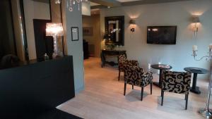 - un salon avec une table, des chaises et une télévision dans l'établissement Astrid Hotel, à Rennes