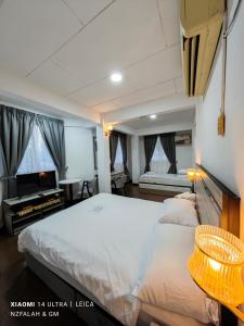 a bedroom with a large bed and a tv in it at Chalet Kurung Tengar in Kuala Perlis +104 photos