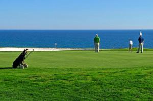 a group of people playing golf near the ocean at Charming Vale Do Lobo Villa Casa Vale Do Lobo 832A 3 Bedrooms in Vale do Lobo