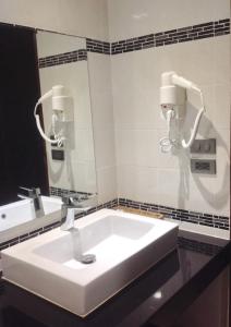 a bathroom with a white sink and a mirror at David Residence in Nai Yang Beach