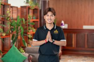 a man standing in a room with his hands at Pich Kunthea Angkor Resort in Phumĭ Kruŏs