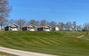 a group of cottages on a hill with a road at Cozy Home In Söderåkra in Söderåkra
