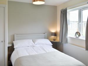 a white bedroom with a bed and a window at Four Dorchester Drive - Uk32042 in Inglewhite +8 photos