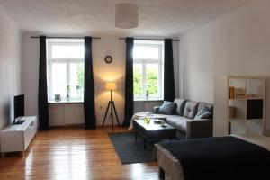 a living room with a bed and a couch at Apartamenty Krakowskie 36 Lublin - Double One in Lublin