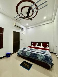 a bedroom with a bed and a ceiling fan at Welcome stay AC ROOM in Ayodhya