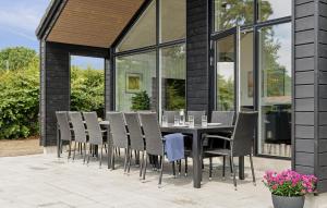 a dining table and chairs on a patio at Amazing Home In Rødby With Wifi in Rødby +26 photos