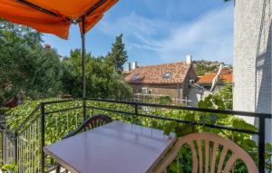 a table and chairs on a balcony with an umbrella at 4 Bedroom Awesome Apartment In Sveti Juraj in Sveti Juraj +25 photos
