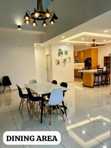 a dining area with a table and chairs at Alur Homestay Villa 4 Bedrooms in Lahad Datu