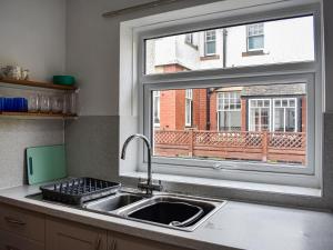 a kitchen with a sink and a window at Tynedale in Keswick +14 photos