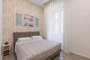 a bedroom with a bed and a large window at b&b don Mimì in Naples