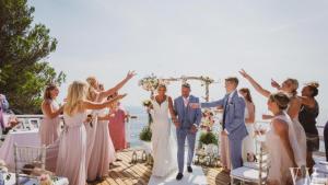 a bride and groom walking down the aisle with their wedding party at Exclusive Seafront Villa,Private Pool,Gym,BBQ in El Toro +70 photos