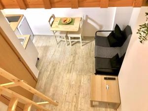 a living room with a table and a couch at e5túdio frt in Peniche