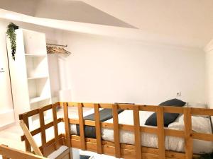 a bedroom with a wooden bunk bed in a room at e5túdio frt in Peniche