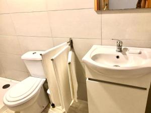 a bathroom with a toilet and a sink at e5túdio frt in Peniche