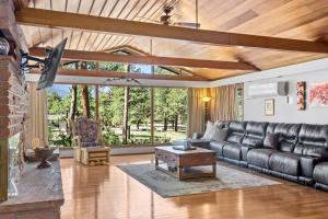 a living room with a leather couch and a table at Panorama Vacation Home by Estes Park Homes home in Estes Park