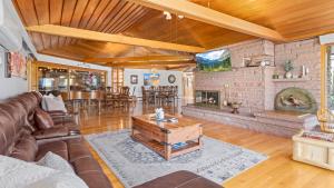 a living room with a couch and a fireplace at Panorama Vacation Home by Estes Park Homes home in Estes Park +55 photos
