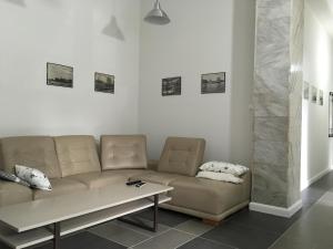 a living room with a couch and a table at Apartament Bankowy in Olecko
