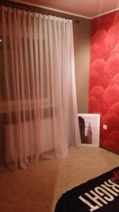 a room with a white curtain and a wall with clouds at Apartments near old town with private parking in Kaunas