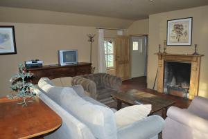 a living room with white furniture and a fireplace at Orshof in Opglabbeek