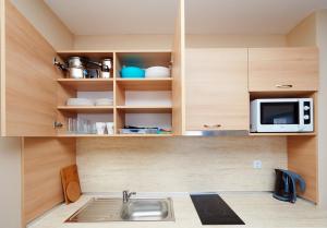 a kitchen with a sink and a microwave at Студио Калина in Pomorie