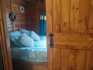 a bedroom with a bed in a wooden cabin at The Hideaway in Želiv